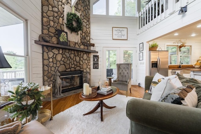 328 Black Ankle Creek Rd, Cherry Log, GA 30522 - living room with a stone fireplace, hardwood / wood-style floors, and wooden walls