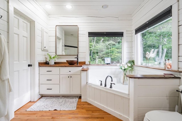 328 Black Ankle Creek Rd, Cherry Log, GA 30522 - bathroom featuring a bathing tub, hardwood / wood-style floors, vanity, and wooden walls