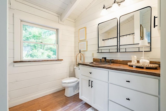 328 Black Ankle Creek Rd, Cherry Log, GA 30522 - bathroom with hardwood / wood-style floors, wood walls, vaulted ceiling with beams, vanity, and toilet