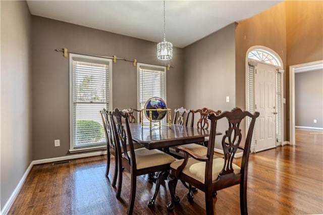 dining space featuring wood finished floors, visible vents, and baseboards