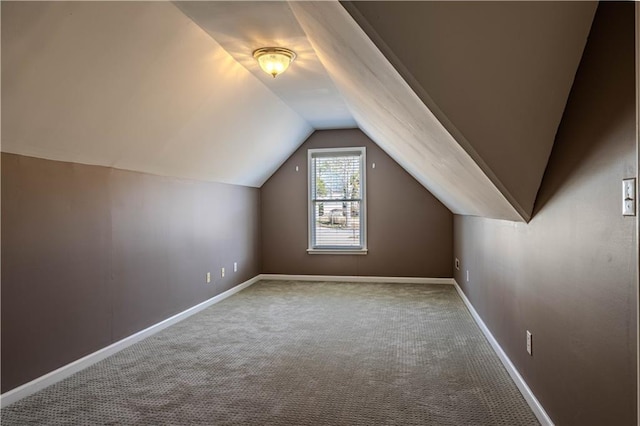 additional living space with carpet floors, baseboards, and lofted ceiling