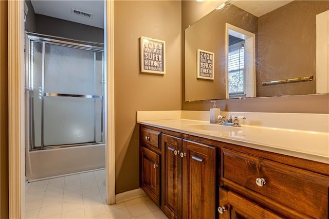 full bath featuring shower / bath combination with glass door, vanity, and visible vents