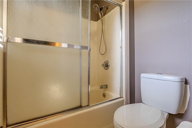 full bathroom with enclosed tub / shower combo and toilet