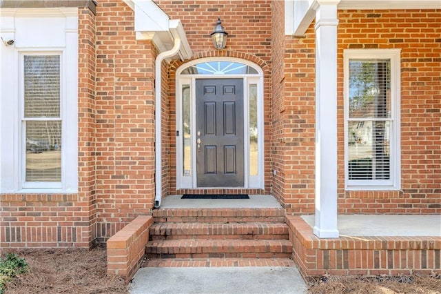 property entrance with brick siding