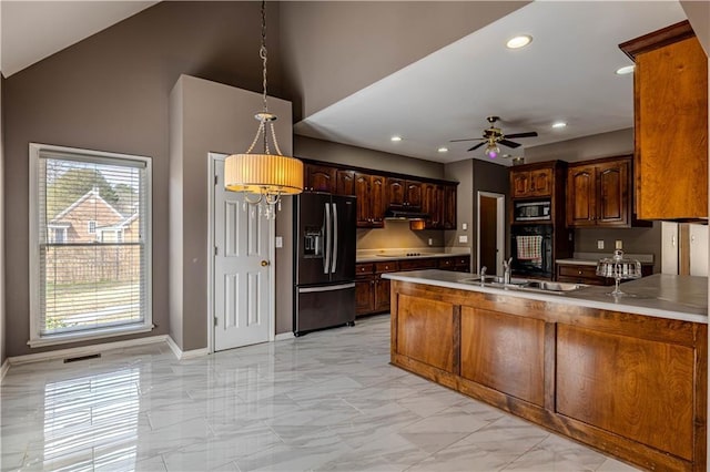 kitchen featuring a peninsula, black appliances, marble finish floor, and vaulted ceiling