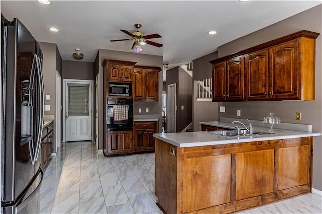 kitchen featuring stainless steel microwave, oven, a peninsula, fridge with ice dispenser, and a sink