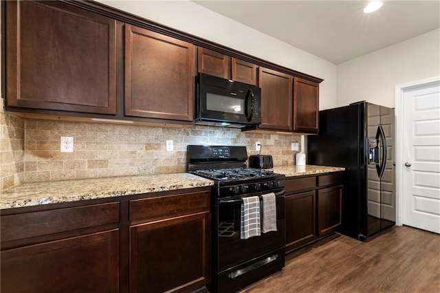 3720 Liverpool Way, Atlanta, GA 30331 - kitchen with backsplash, dark hardwood / wood-style flooring, black appliances, light stone countertops, and dark brown cabinets
