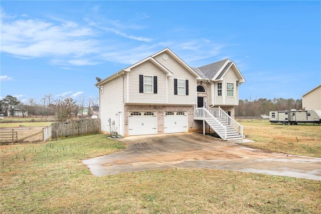 split foyer home featuring a garage and a front yard