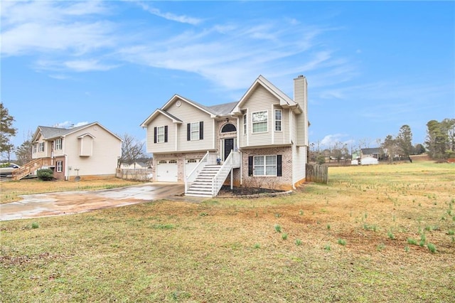 bi-level home featuring a garage and a front yard