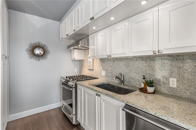 kitchen with white cabinetry, range hood, and appliances with stainless steel finishes