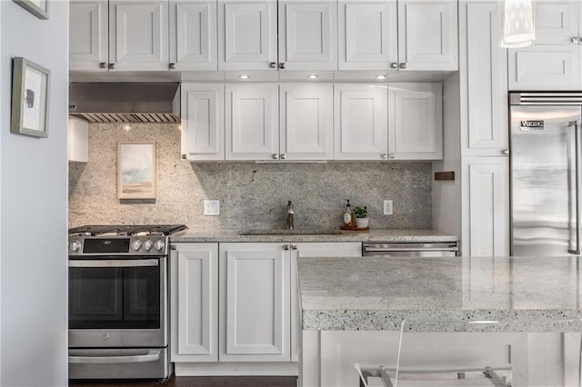 kitchen with sink, backsplash, extractor fan, white cabinets, and appliances with stainless steel finishes