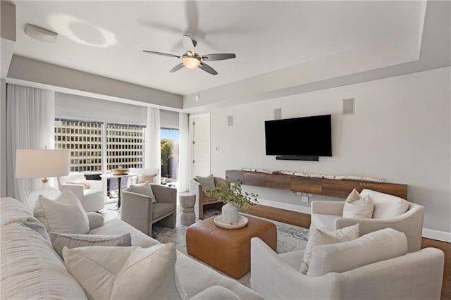 living room featuring hardwood / wood-style floors and ceiling fan