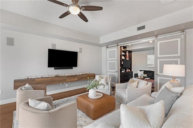 living room featuring light hardwood / wood-style floors and ceiling fan