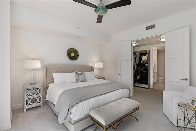 carpeted bedroom featuring ceiling fan and ensuite bathroom