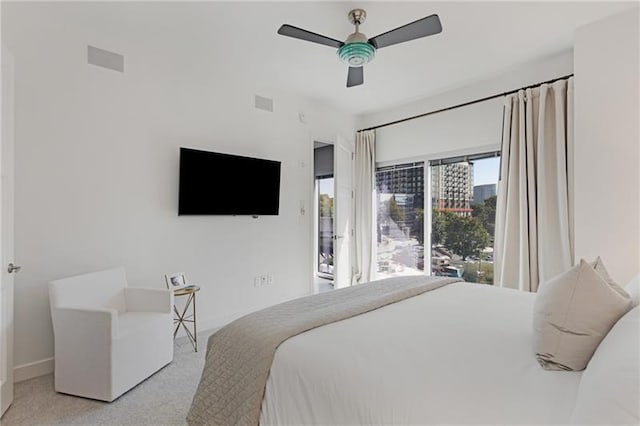 bedroom with ceiling fan and light carpet