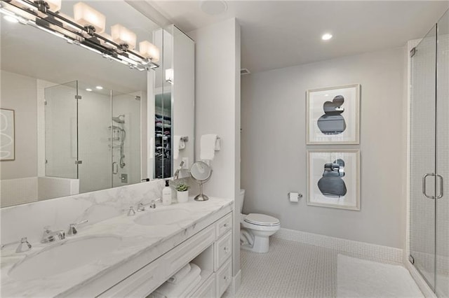 bathroom featuring tile patterned flooring, vanity, toilet, and an enclosed shower