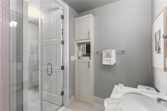 bathroom with tile patterned flooring, walk in shower, and sink