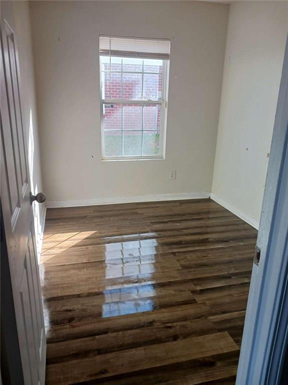 spare room with dark hardwood / wood-style floors