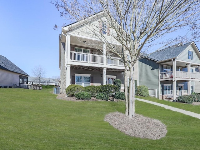 view of front of property with central air condition unit and a front yard