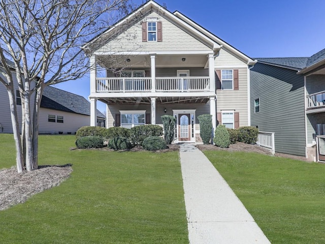 view of front of home featuring a front lawn and a balcony