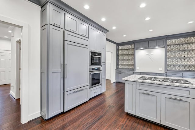 kitchen featuring gray cabinetry, light stone counters, and appliances with stainless steel finishes