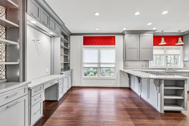 kitchen featuring gray cabinetry, built in study area, dark wood-style flooring, and open shelves