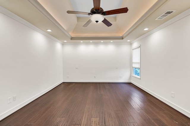 empty room with baseboards, dark wood-style floors, visible vents, and a ceiling fan