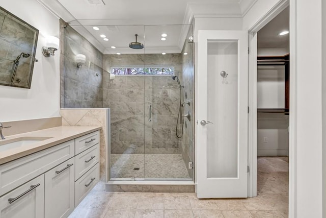 bathroom featuring vanity, a stall shower, recessed lighting, and crown molding