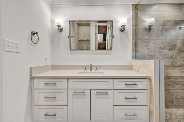 bathroom featuring crown molding, a walk in shower, and vanity
