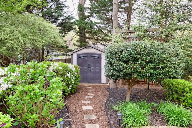 view of shed featuring fence