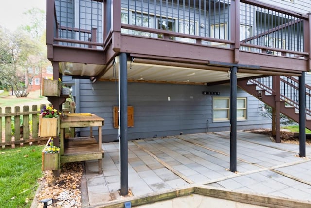 view of patio featuring stairs and fence