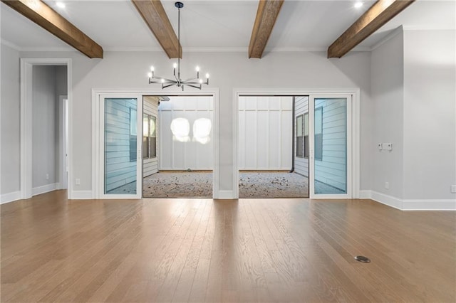 entrance foyer with a notable chandelier, baseboards, wood finished floors, and beamed ceiling