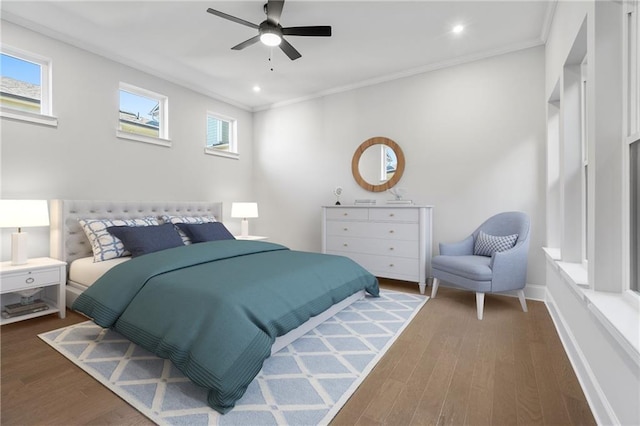 bedroom with recessed lighting, crown molding, baseboards, and wood finished floors