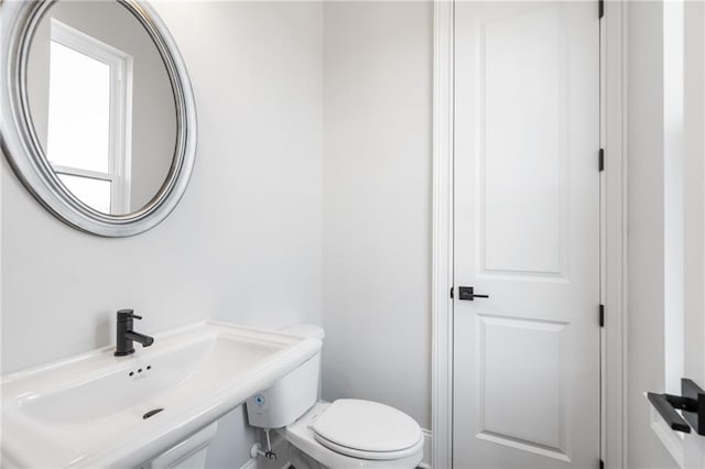 half bathroom with a sink and toilet