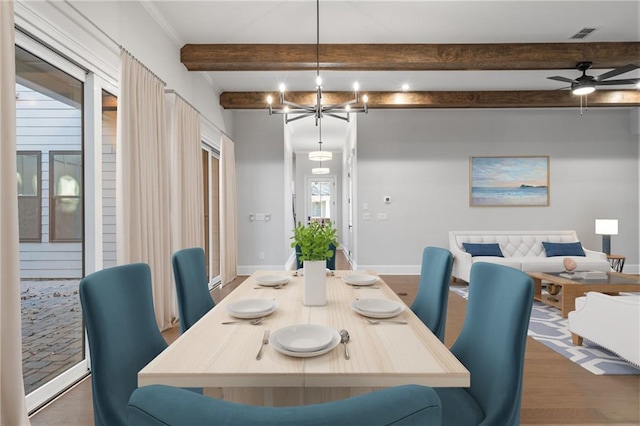 dining area with an inviting chandelier, beam ceiling, baseboards, and wood finished floors