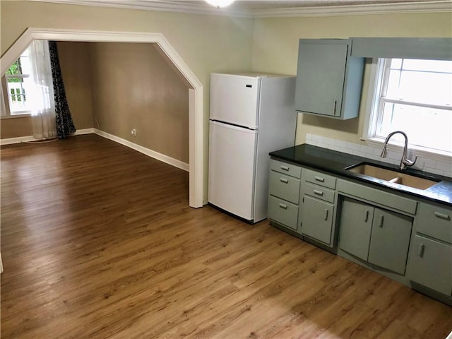 116 Nation Dr, Calhoun, GA 30701 - kitchen with sink, crown molding, green cabinetry, white refrigerator, and dark hardwood / wood-style flooring