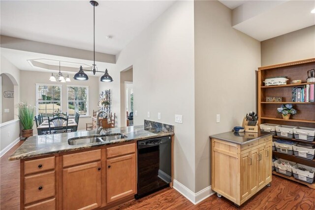 kitchen with hardwood / wood-style floors, sink, hanging light fixtures, black dishwasher, and a chandelier