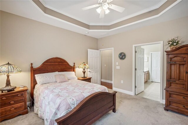 bedroom with light carpet, a raised ceiling, ceiling fan, and ornamental molding