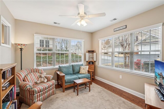 living area featuring ceiling fan and light hardwood / wood-style floors