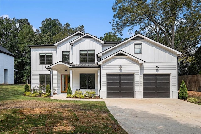 modern inspired farmhouse featuring a garage and a front lawn