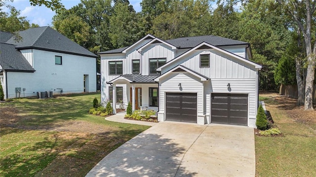 modern inspired farmhouse with a garage and a front lawn