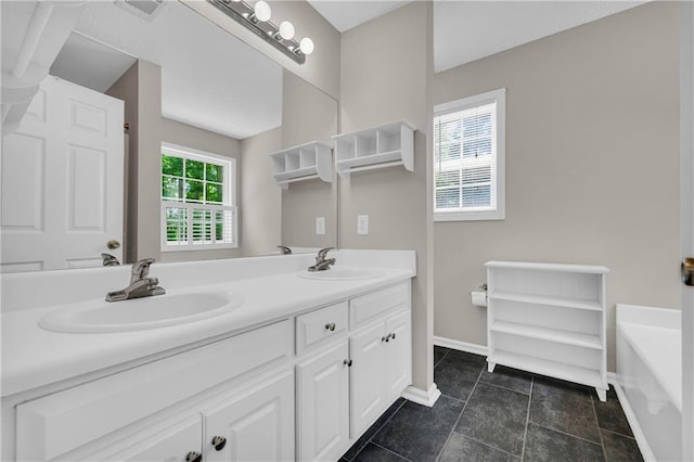 bathroom featuring baseboards, double vanity, and a tub