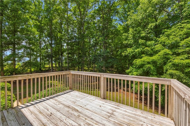 wooden terrace with view of wooded area