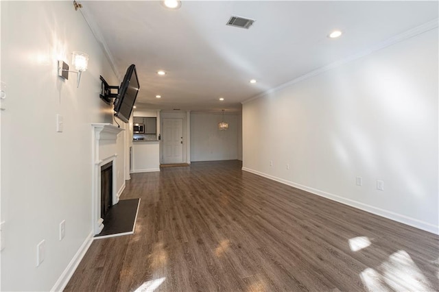 unfurnished living room with ornamental molding and dark wood-type flooring