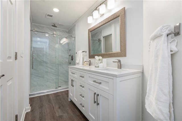 bathroom with vanity, hardwood / wood-style flooring, and an enclosed shower