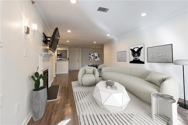 living room with hardwood / wood-style flooring and ornamental molding