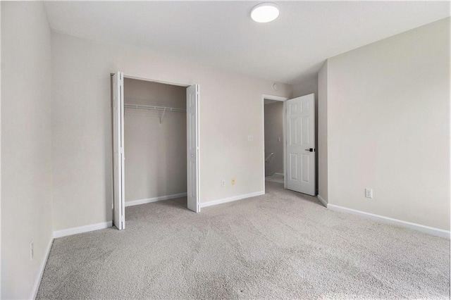 unfurnished bedroom with carpet floors, baseboards, and a closet