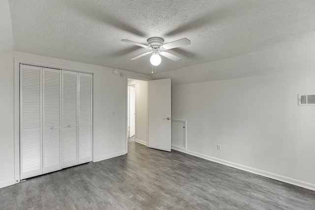 unfurnished bedroom with visible vents, baseboards, wood finished floors, a closet, and a ceiling fan