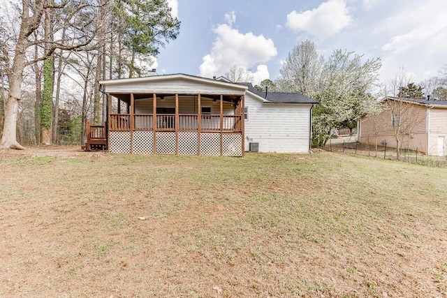 back of house with crawl space, a lawn, central AC, and fence