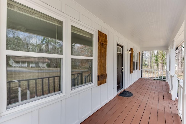 wooden terrace featuring covered porch